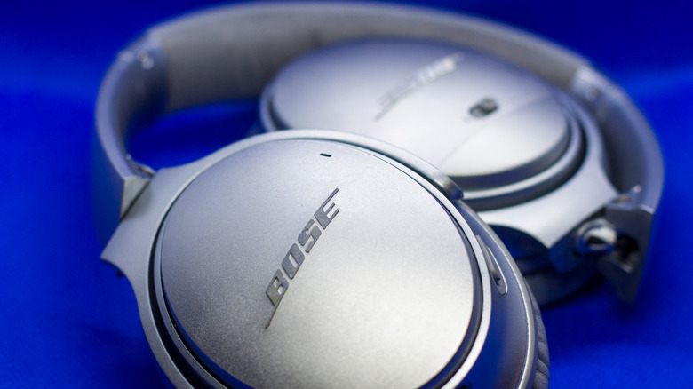 Close up of Bose headphones on a blue background