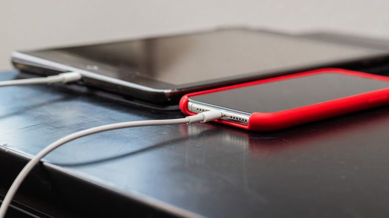 Smartphone and tablet charging via USB, side by side.