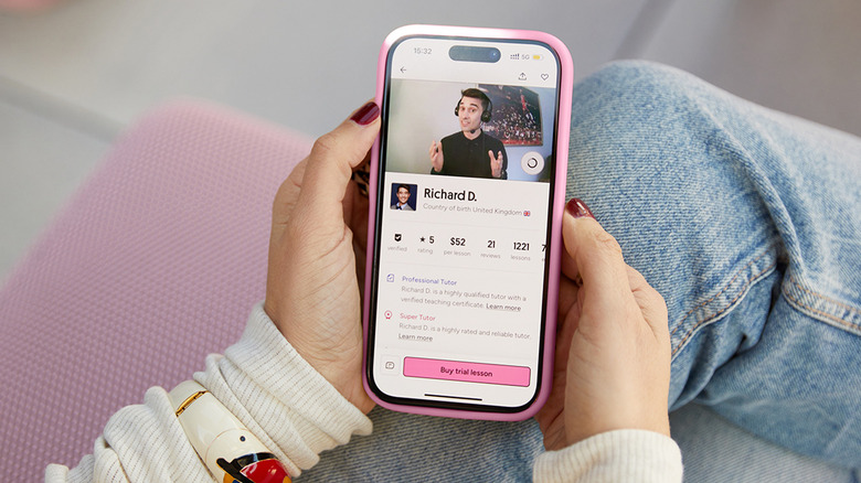 Hands holding a phone with the Preply app open