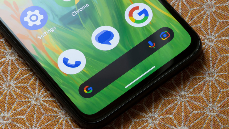 close up of android phone with google phone an google messages app icons visible