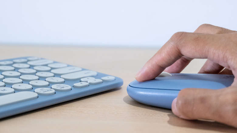 A person using a wireless mouse and keyboard combo.