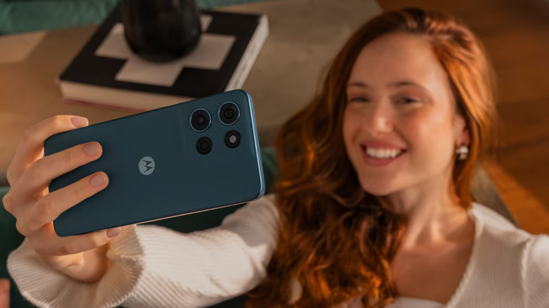 Person holding Motorola Moto G Play 5G (2026) while taking selfie