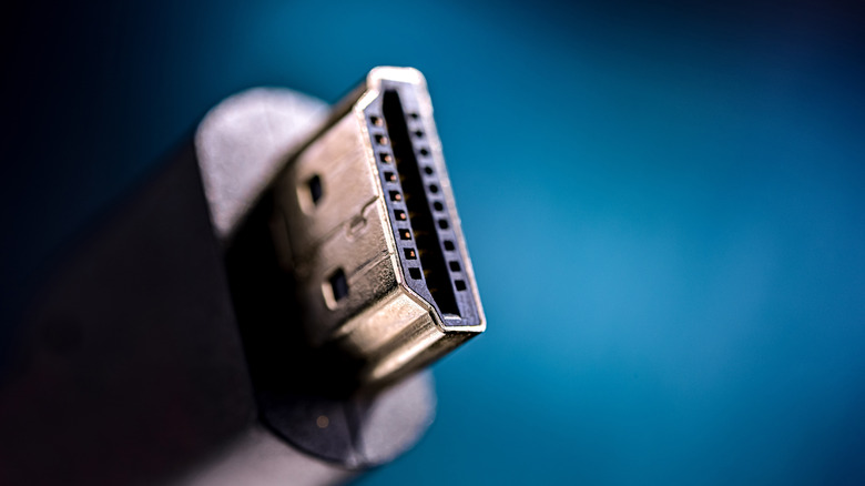 Close-up of an HDMI cable connection against a blue background