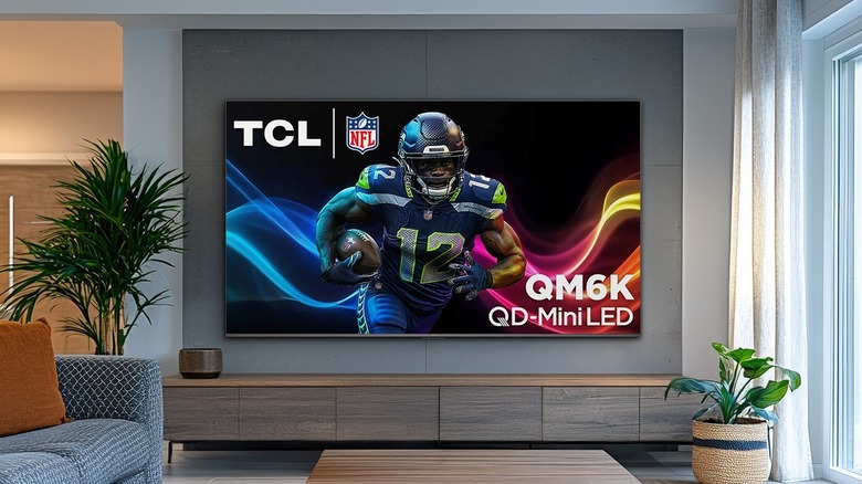 TCL QM6K TV mounted to a wall in a living room