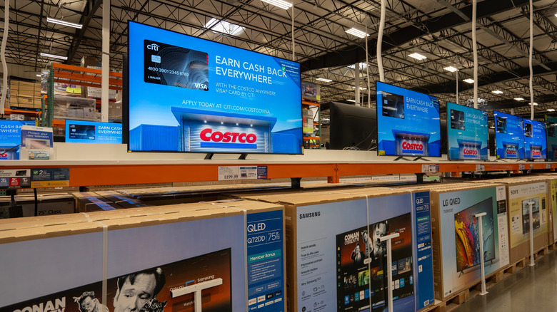 Several TVs on sale at a Costco store.