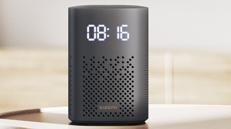 Xiaomi Smart Speaker with a digital clock display on a table.