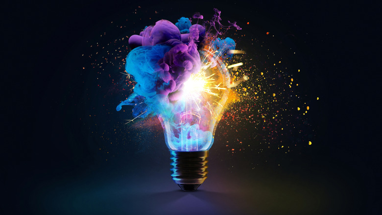 Colorful rendering of old lightbulb exploding with light and dust.