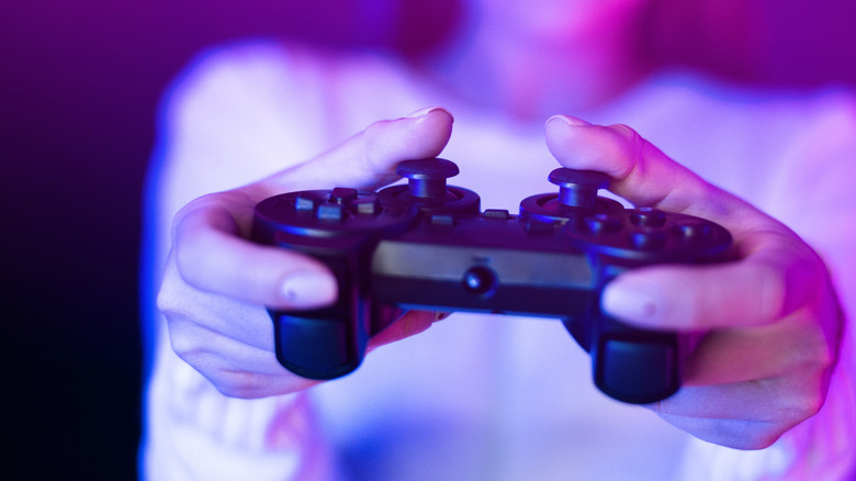 Woman holding a generic game controller in both hands