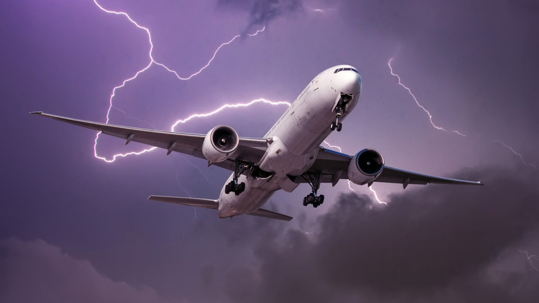landing airplane with lightning in the background