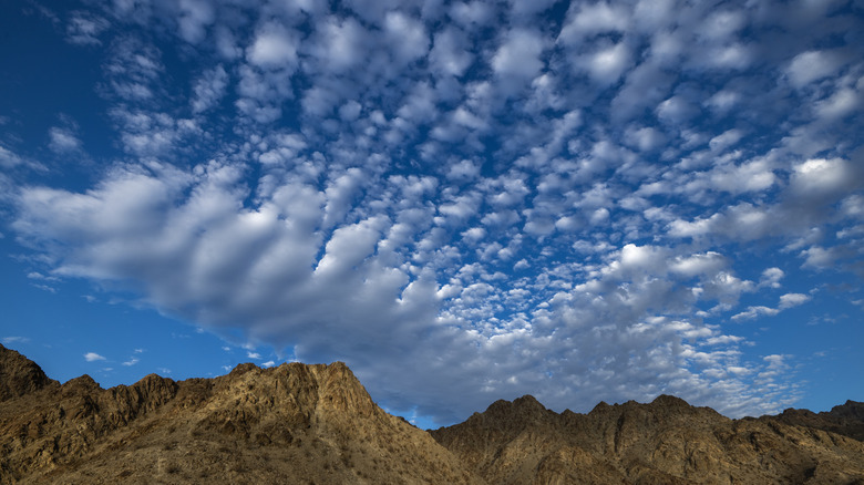 linear, wave-like clouds over the mountains