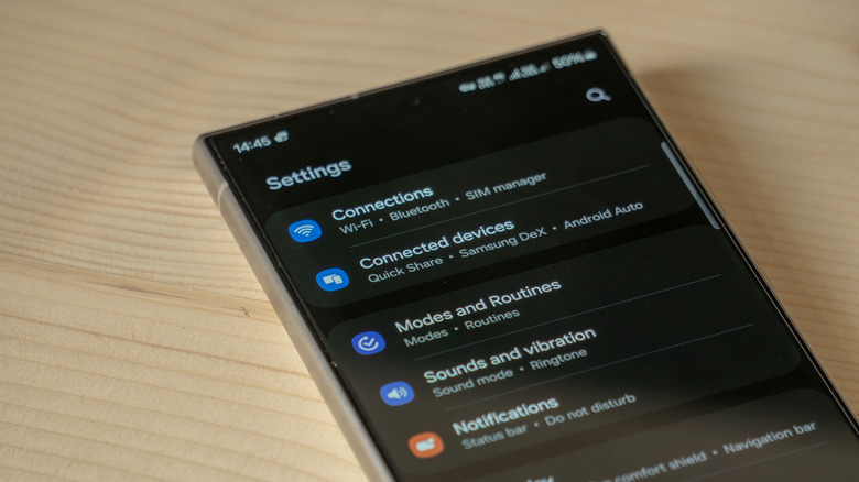 A cell phone shows its settings screen with Blluetooth on and a list of connected devices