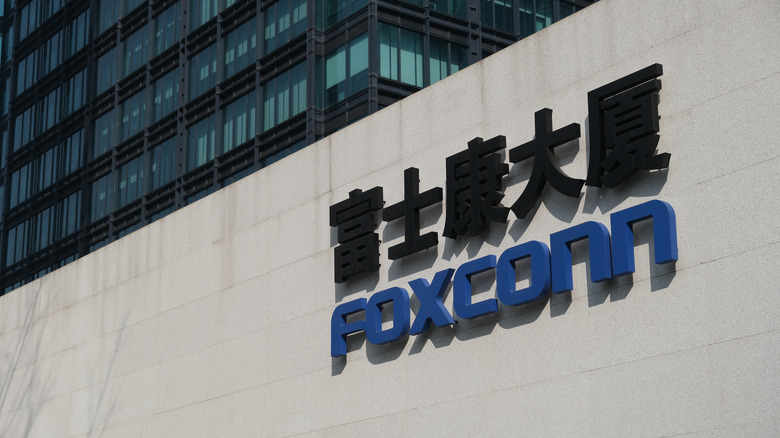 Exterior of a Foxconn building with the company's logo on the side