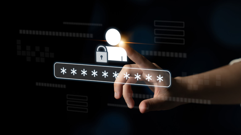 A finger touching a screen showing the icon of a person beside a lock graphic on top of a password text field