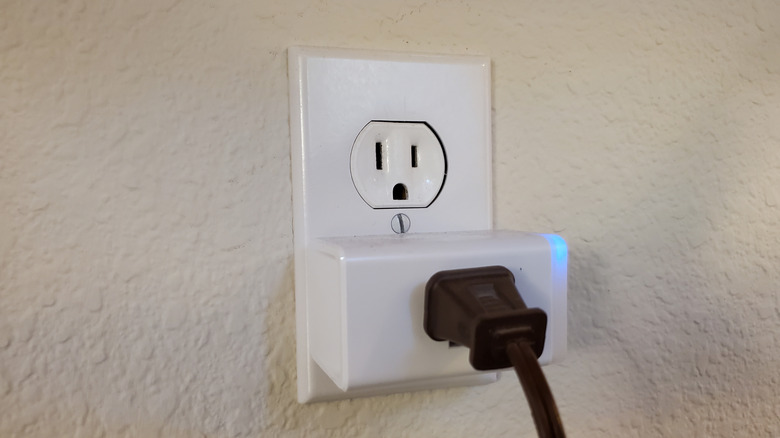 Close-up of a TP Link smart plug with an appliance attached in a smart home