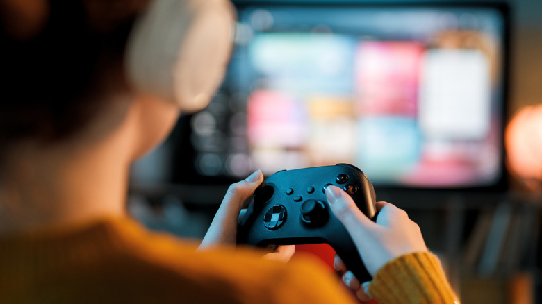person playing video games on laptop