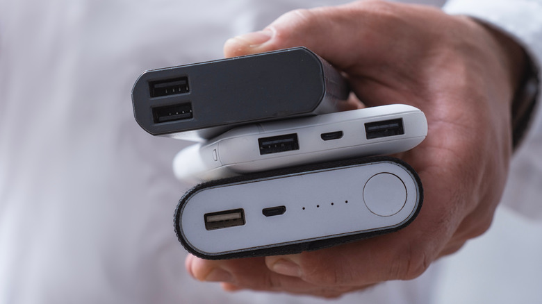 Close-up of a hand holding multiple power banks