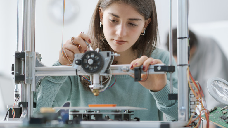 Person working on 3D printer
