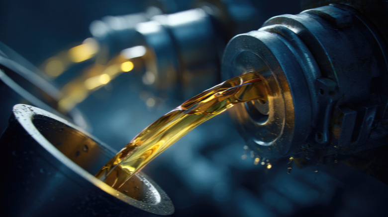 Close-up of lubricant being poured between containers