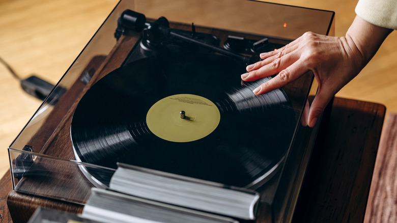 Close-up of person's hand on turntable