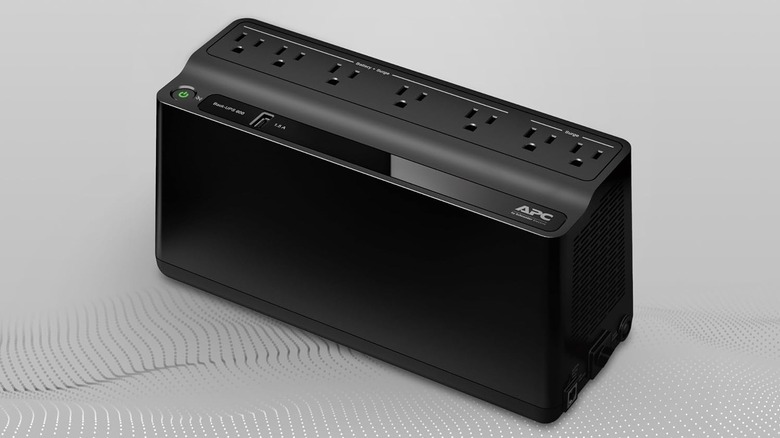 The APC BE600M1 UPS against a grey background