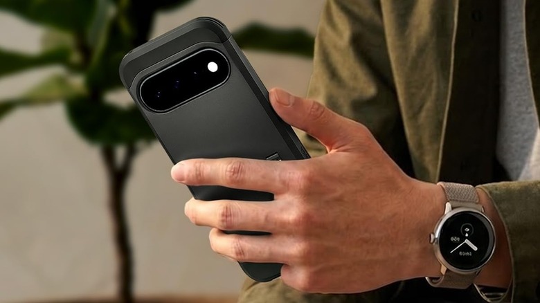 Close-up of a person holding a phone with Spigen Tough Armor MagFit case