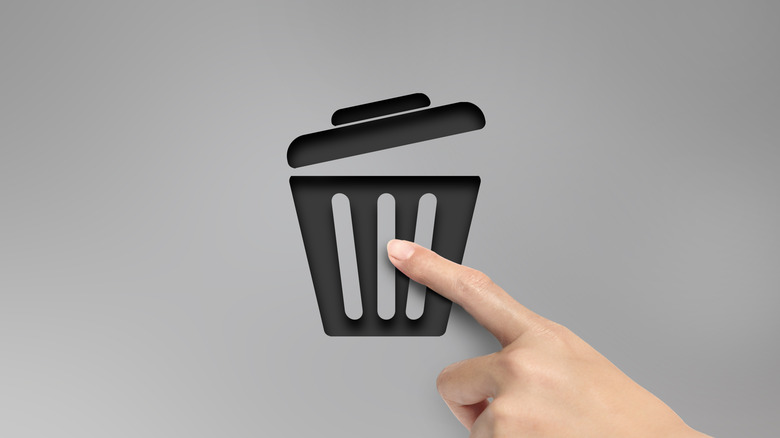 An illustration showing a hand pressing a trash can icon