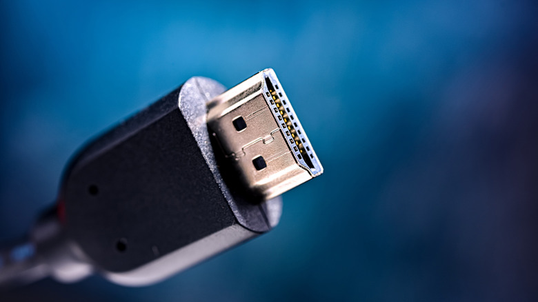 Male end of an HDMI cable against a blue background