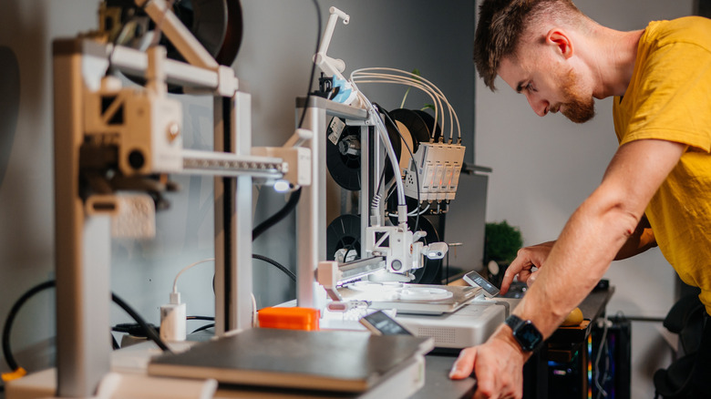 Young man working on 3D printer
