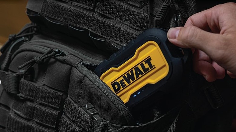 A DeWalt Heavy Duty Portable Charger in the pocket of a backpack