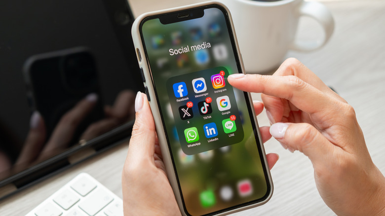 Close-up of person choosing apps on iPhone