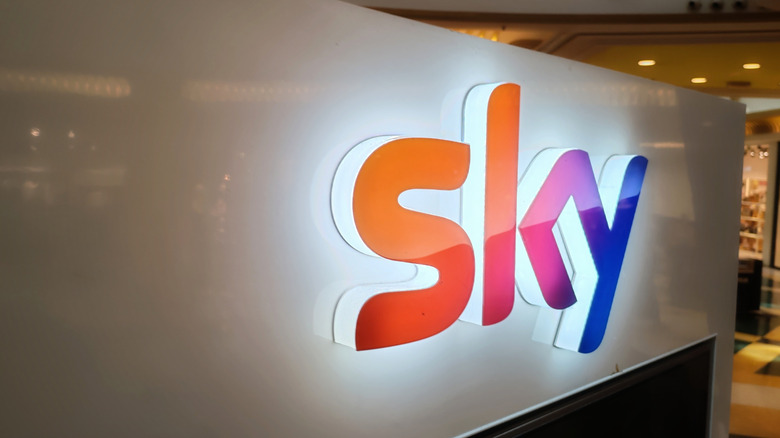 A luminous Sky sign inside a shopping mall