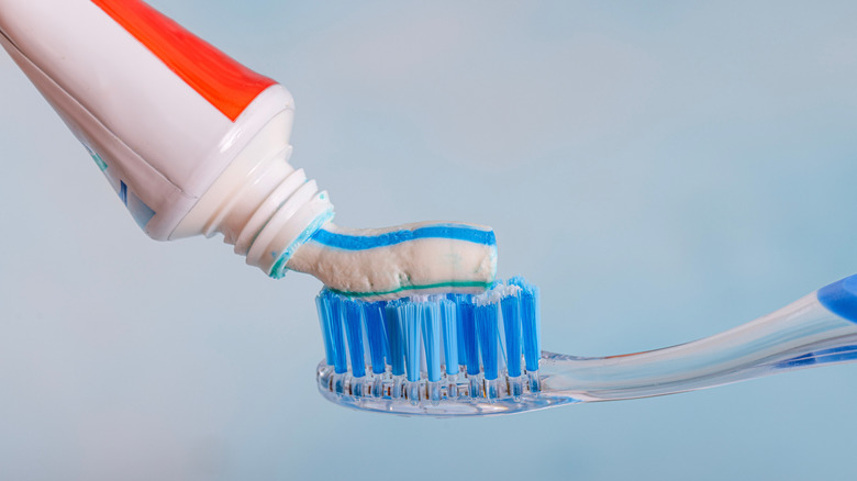 Putting toothpaste on a toothbrush