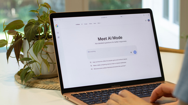 A person using Google's AI Mode on a laptop.