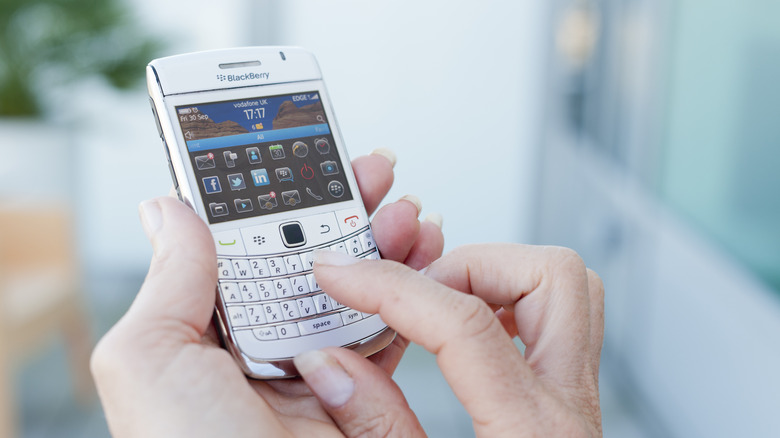 Close-up of person's hands using BlackBerry device