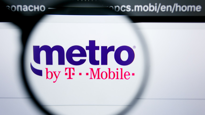 Graphic that shows the Metro by T-Mobile logo under a magnifying glass on a website.