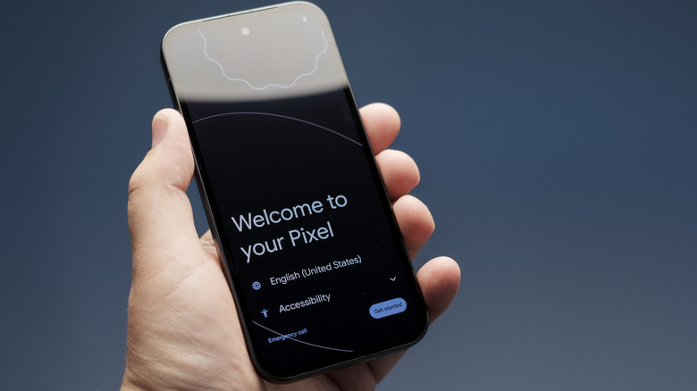 Person's hand holding a Google PIxel 9a showing the welcome screen