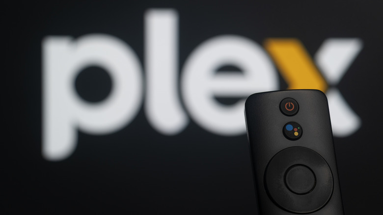 Blurred Plex logo on screen with in focus remote control in front
