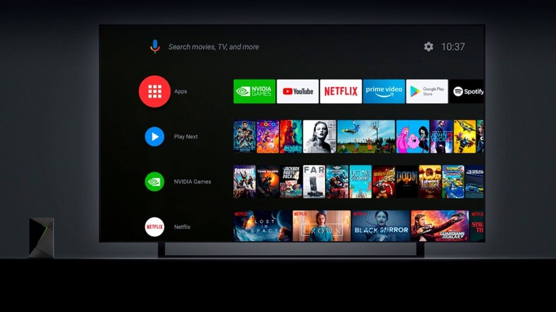 Nvidia Shield TV Pro placed next to a TV with the Android TV interface on its screen