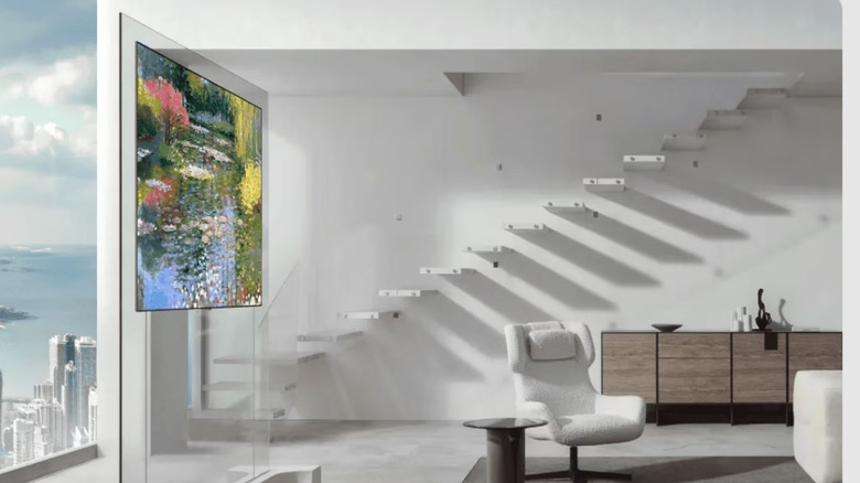 A slim OLED TV mounted on a pane of glass