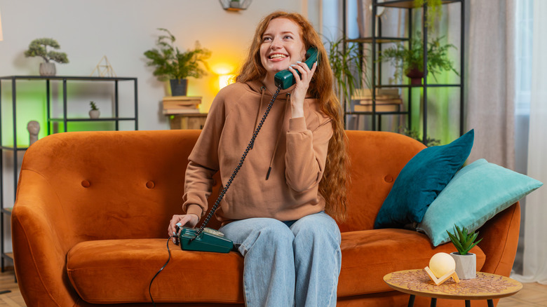 Person using landline phone at home