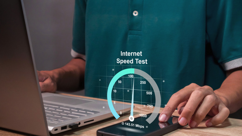 concept image of a person using a phone to run an internet speed test