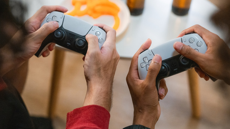 People gaming with DualSense PS5 controllers