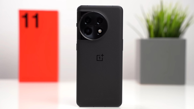 OnePlus 11 placed on a white surface with its packaging in the background