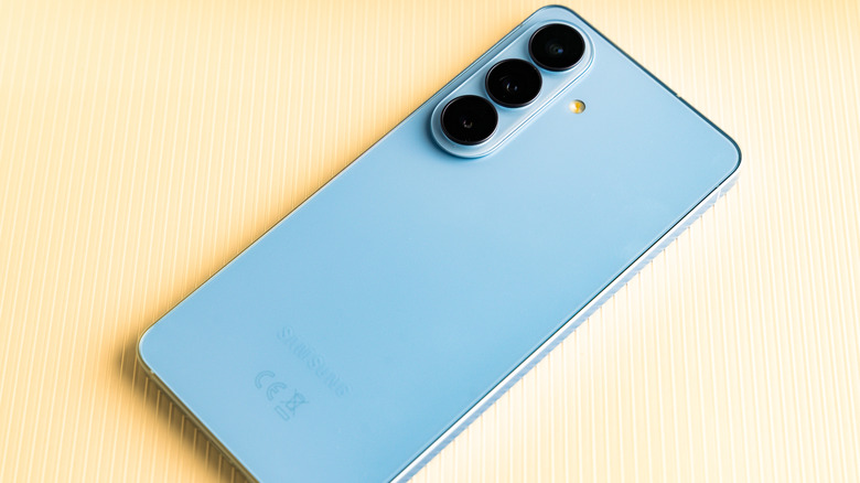 Back view of blue Samsung Galaxy S24 smartphone with triple cameras