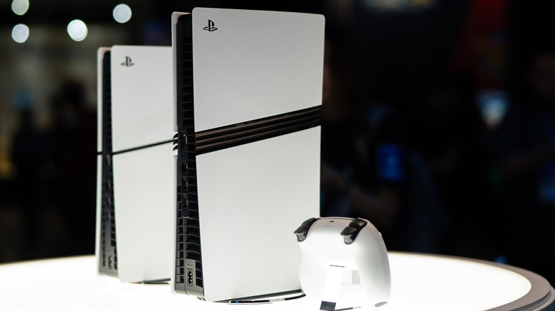 PlayStation 5 new models including Pro standing next to each other with a controller