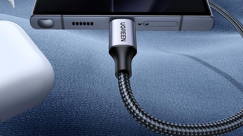 Close-up of a Ugreen USB-C cable connected to a USB port on a phone