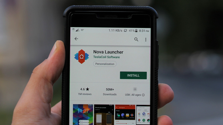 Nova Launcher Play Store listing showed on screen of phone held in hand
