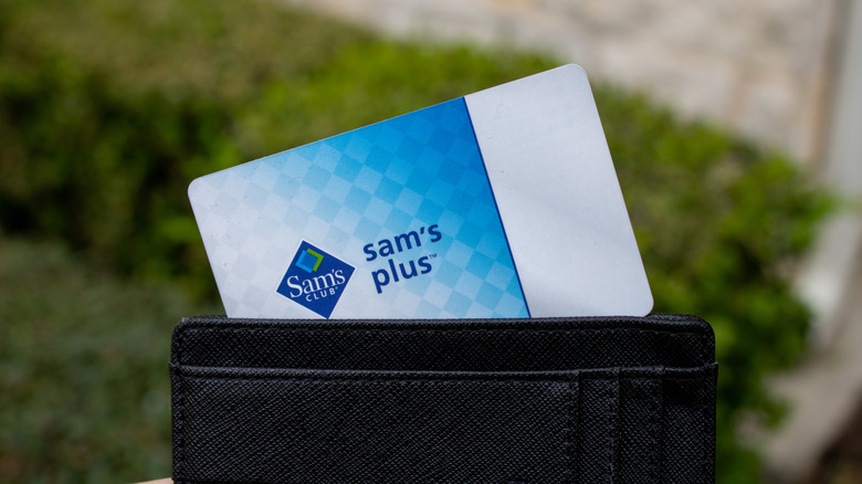 Sam's Plus membership card peaking out of wallet showing logo and name in text