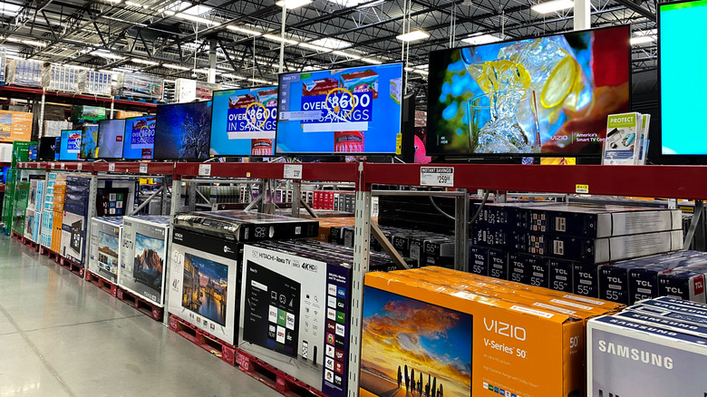 TV shelf at Sam's Club showing several TVs and their boxes