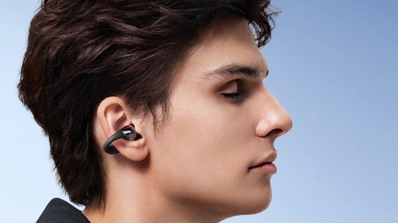 Person enjoying clip-on earbuds
